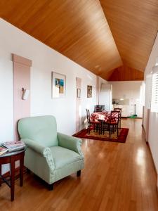 a living room with a chair and a table at Kamerlingh Villa in Oranjestad