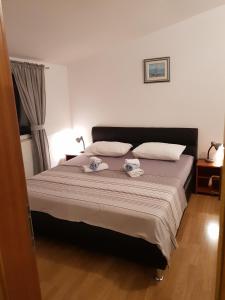 um quarto com uma cama com duas toalhas em Mali Lovre em Poljica
