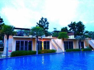 a house with a swimming pool in front of a house at BANGKOK.GRAND.RESORT in Bang Bo