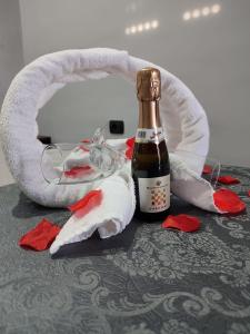 a bottle of champagne next to a christmas decoration at Diora Suite in Pompei +20 photos