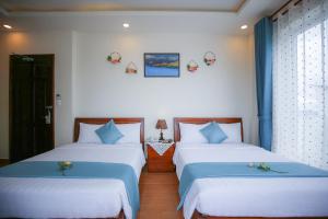 Postel nebo postele na pokoji v ubytování Rose Valley Hotel Da Lat Vietnam