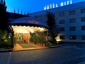 a hotel with an entrance to a building at night at Hotel Bifi in Casalmaggiore