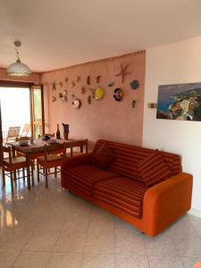 a living room with a couch and a dining table at DONNA CONCETTA HOUSE in Ravello