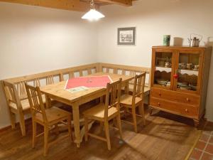 a dining room with a table and chairs and a cabinet at Kellerstöckl Weber in Güssing