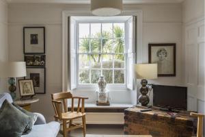 a living room with a window and a tv at Antonia's Pearls in St Austell