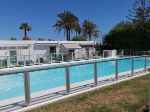 a house with a swimming pool next to a house at Seaside bungalow in Maspalomas