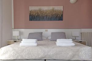a bedroom with a bed with two pillows on it at Pietrasantamare in Marina di Pietrasanta