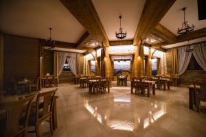 a dining room with wooden tables and chairs at Miodowy Dworek in Bukowina Tatrzańska