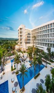 an aerial view of a resort with a pool and palm trees at Dreams Karibana Cartagena Golf & Spa Resort in Cartagena de Indias