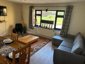 a living room with a couch and a table at Lower grange park in Chacombe