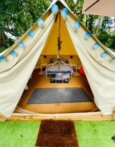 a tent with a bed in the middle at Garden County Glamping in Newtown Mount Kennedy