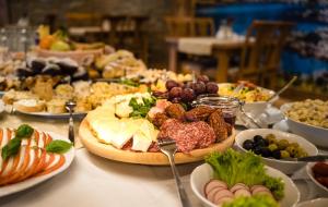 a table with many plates of food on it at Miodowy Dworek in Bukowina Tatrzańska +34 photos