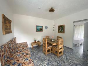 a living room with a table and a couch at Villa Coconut in La Verita