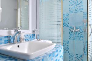 a bathroom with a sink and a shower at Villa Reverenza in Lixouri +54 photos