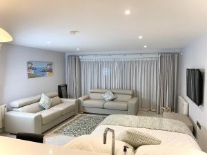 uma sala de estar com uma cama e um sofá em The North Cove, 20m to the Sea, Modern Studio Apartment em Portrush