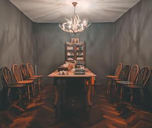 a dining room with chairs and a table and a chandelier at J No.14 in Bangkok