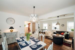 a dining room and living room with a table and chairs at Ferienwohnung am Lindbruch in Niederkrüchten