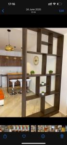 a living room with a wooden partition with a table at Sea Star Apartments in Ulcinj