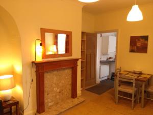 a living room with a fireplace and a mirror at Apartment with Outside Patio and Car Space in Durham