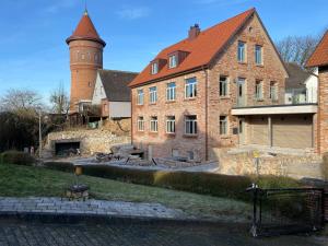 a large brick building with a tower on top of it at Apartment Deluxe - a64667 in Bad Segeberg
