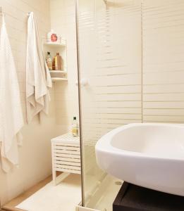 a white bathroom with a tub and a sink at Rambla - Palma center in Palma de Mallorca