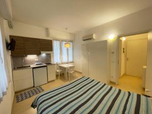 a hotel room with a bed and a table at Residence Glicini in Finale Ligure