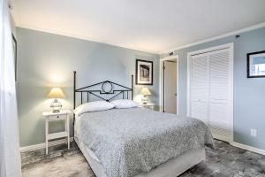 a bedroom with a bed and two tables with lamps at Walk to Boardwalk! Waterfront Ocean City Condo in Ocean City