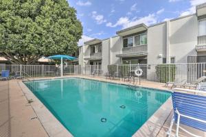a swimming pool in front of a building at Chic Scottsdale Home with Balcony, Walk to Old Town! in Scottsdale
