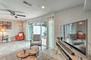 a living room with a large flat screen tv at Chic Scottsdale Home with Balcony, Walk to Old Town! in Scottsdale