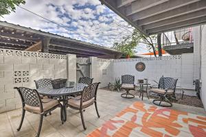 a patio with a table and chairs and a fence at Chic Scottsdale Home with Balcony, Walk to Old Town! in Scottsdale