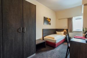 Postel nebo postele na pokoji v ubytování Hotel Bloemfontein
