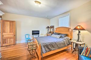 - une chambre avec un lit en bois dans l'établissement Historic Watson Brick House with Private Deck!, à Danville