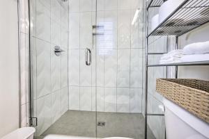 a shower with a glass door in a bathroom at Boise Townhome with Rooftop Deck, 2 Mi to Downtown! in Boise +33 photos