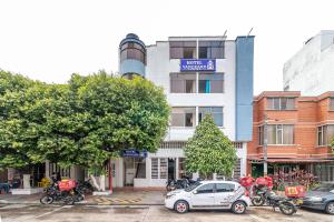 a car parked in front of a building with motorcycles at Ayenda Vanguard in Yopal