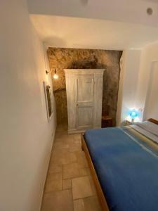 a bedroom with a blue bed and a door at Casa Corallo in Peschici
