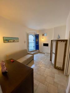 a living room with a couch and a table at Casa Corallo in Peschici