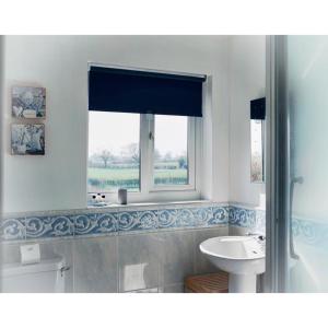 a bathroom with a sink and a mirror at The Moorhead Bed & Breakfast in Wem