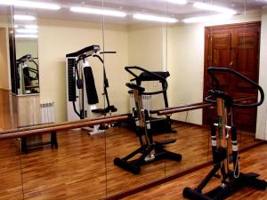 a gym with two exercise bikes and a mirror at Hotel el Sol in Lanjarón