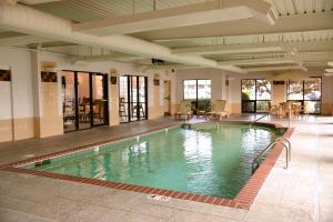 a large swimming pool in a building at La Quinta by Wyndham Springfield South in Springfield