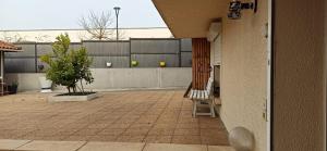 a building with a patio with a table and chairs at Les Caraïbes in Peyrehorade