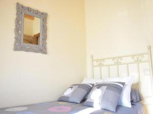 a bedroom with a bed with a mirror on the wall at Casa Rural Vistas de Castilla VILLOVELA DE PIRON in Villovela de Pirón