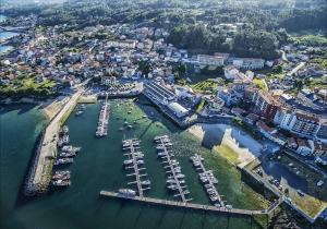 an aerial view of a harbor with boats in the water at Apartamento playa in Boiro