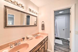 a bathroom with two sinks and a mirror at Cozy Stigler Escape, Walk to Lake Eufaula! in Eufaula +23 photos