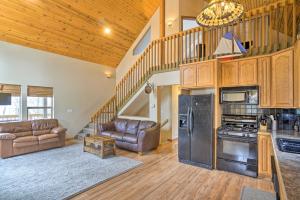een grote woonkamer met een keuken en een trap bij Spacious Buckeye Lake Home with Hot Tub and Fire Pit! in Buckeye Lake