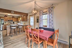 a kitchen and dining room with a table and chairs at about 1 Mi to Lake Secluded Poconos Home with Decks in Jim Thorpe