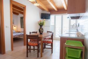a kitchen and dining room with a table and chairs at Stella Maris Marzamemi Apartments in Marzamemi