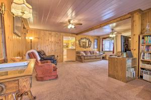 a living room with wooden walls and a ceiling at Cozy Home with Hot Tub Half Mi to Salmon River! in Salmon