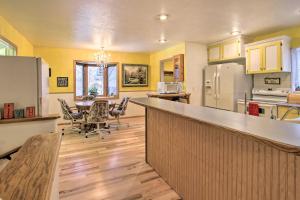a kitchen with a counter and a table with chairs at Cozy Home with Hot Tub Half Mi to Salmon River! in Salmon