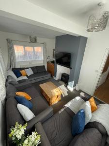 a living room with a couch and a tv at Huge 6 Bedroom House in Sheringham in Sheringham