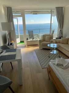 a living room with a view of the ocean at Top - Seaside Appartement mit Meerblick in Timmendorfer Strand